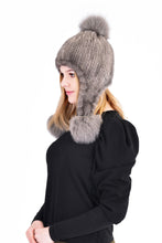 Knitted mink hat with fox pom pom